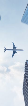 low-angle-view-business-buildings-with-plane-flying-72